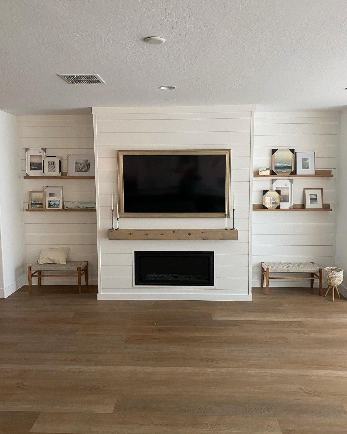 20 mil LVP Flooring: 6 Install Ideas for Home & Commercial Spaces 1 Light wood-colored luxury vinyl plank flooring in a modern living room with a white fireplace.