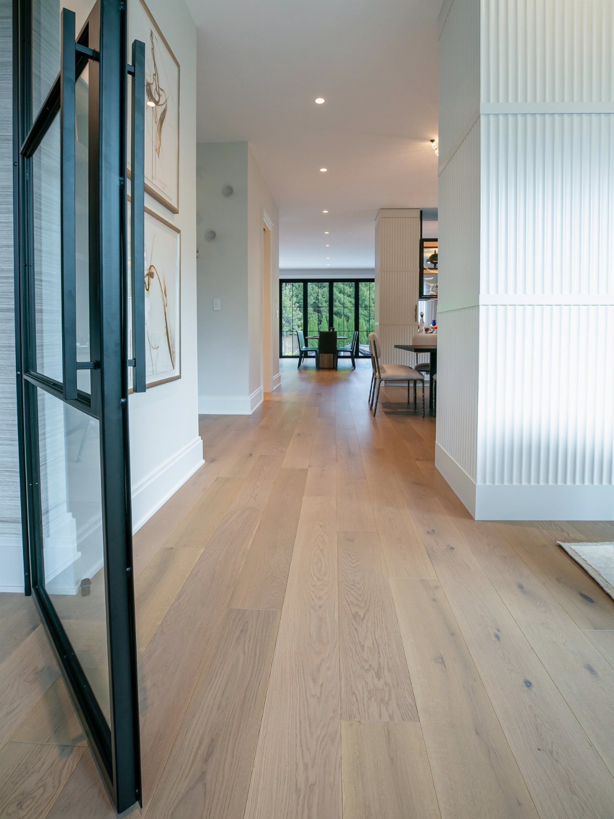 20 mil LVP Flooring: 6 Install Ideas for Home & Commercial Spaces 3 Light wood-toned vinyl plank flooring installed in a bright, modern home hallway.