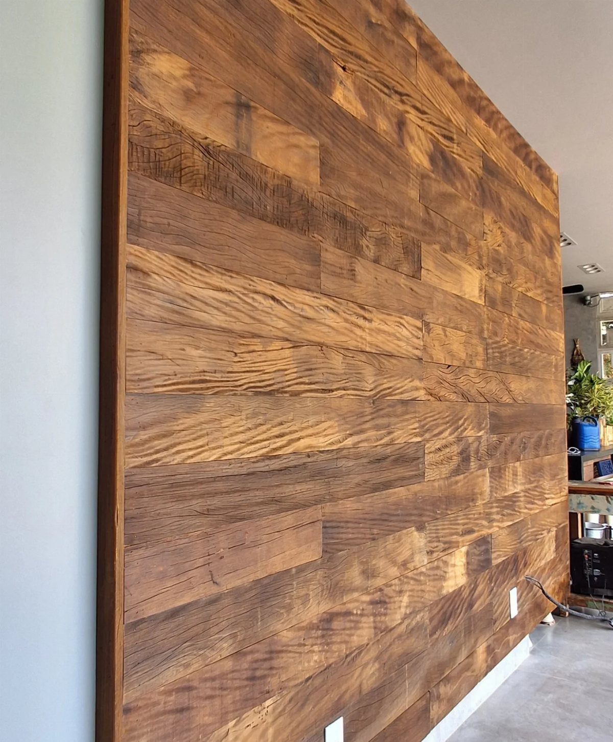 10 Accent Wall Panels for Every Room Style 10 Horizontal wooden planks forming a textured brown accent wall in a modern room.