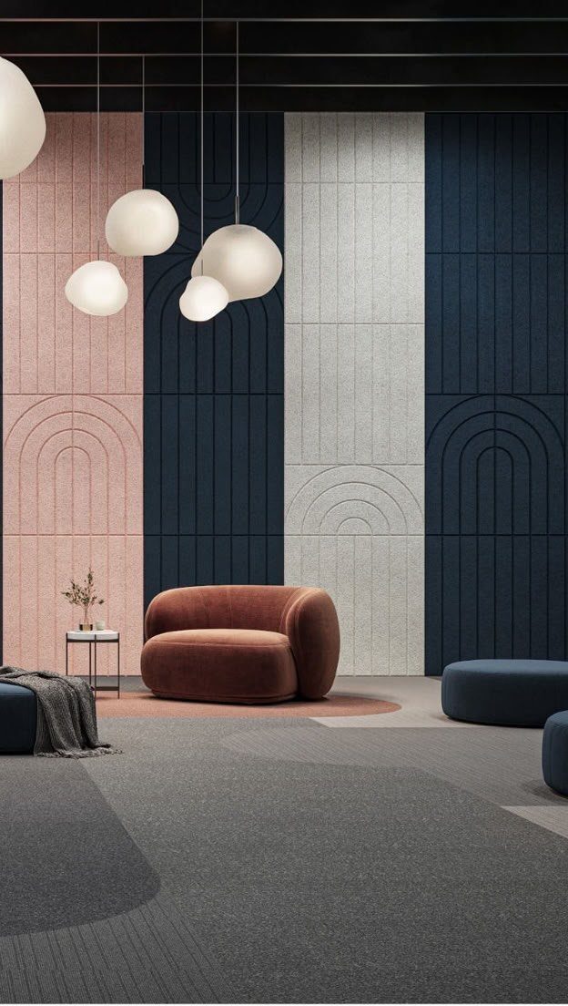 Acoustic wall panels with arched patterns in pink, navy, and white decorate a modern lounge.