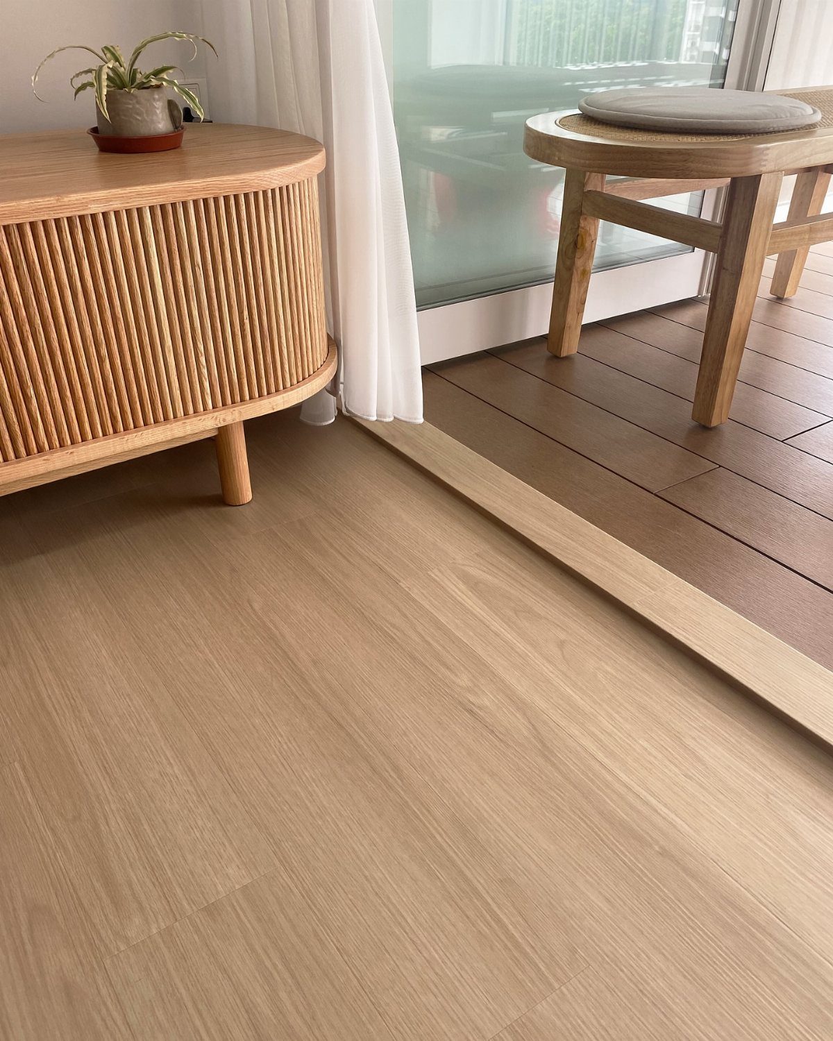 Light-colored wood flooring with a fine grain pattern in a modern interior setting.