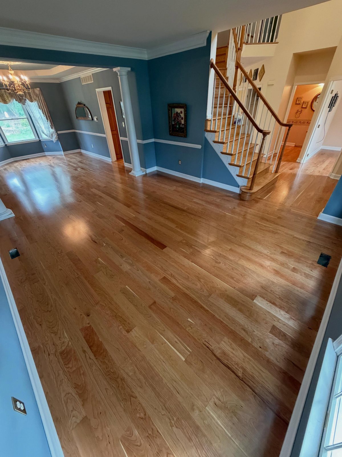 Floor and Wall Color Combinations: 27 Rooms That Get It Right 3 Cherry hardwood floors meet blue walls with white trim in a spacious living room.