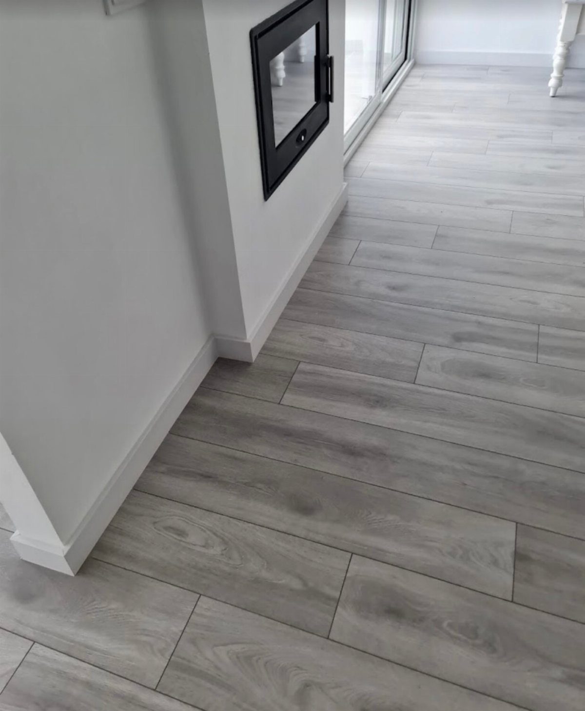Floor and Wall Color Combinations: 27 Rooms That Get It Right 7 Gray hardwood plank flooring installed in a room with white walls and baseboards.