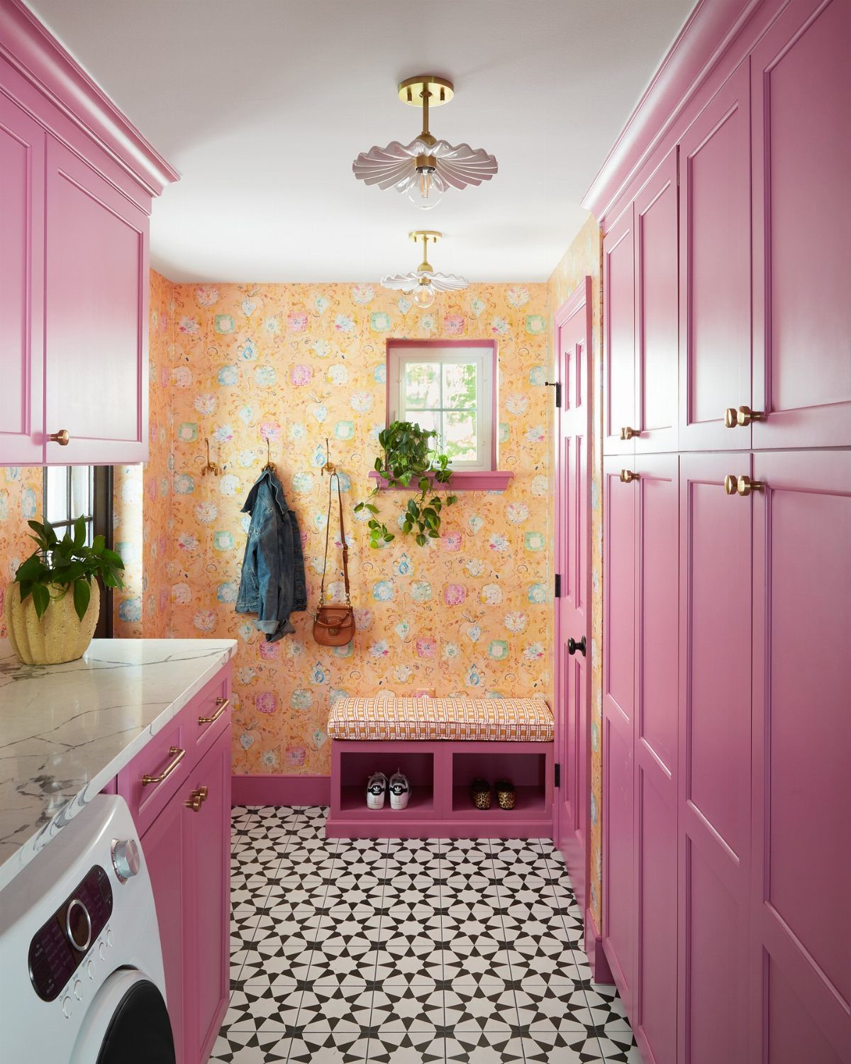 Floor Tile for Laundry Room: 11 Styles That Hold Up to Real Life 3 Pink laundry room cabinets with black and white geometric floor tiles and floral wallpaper.