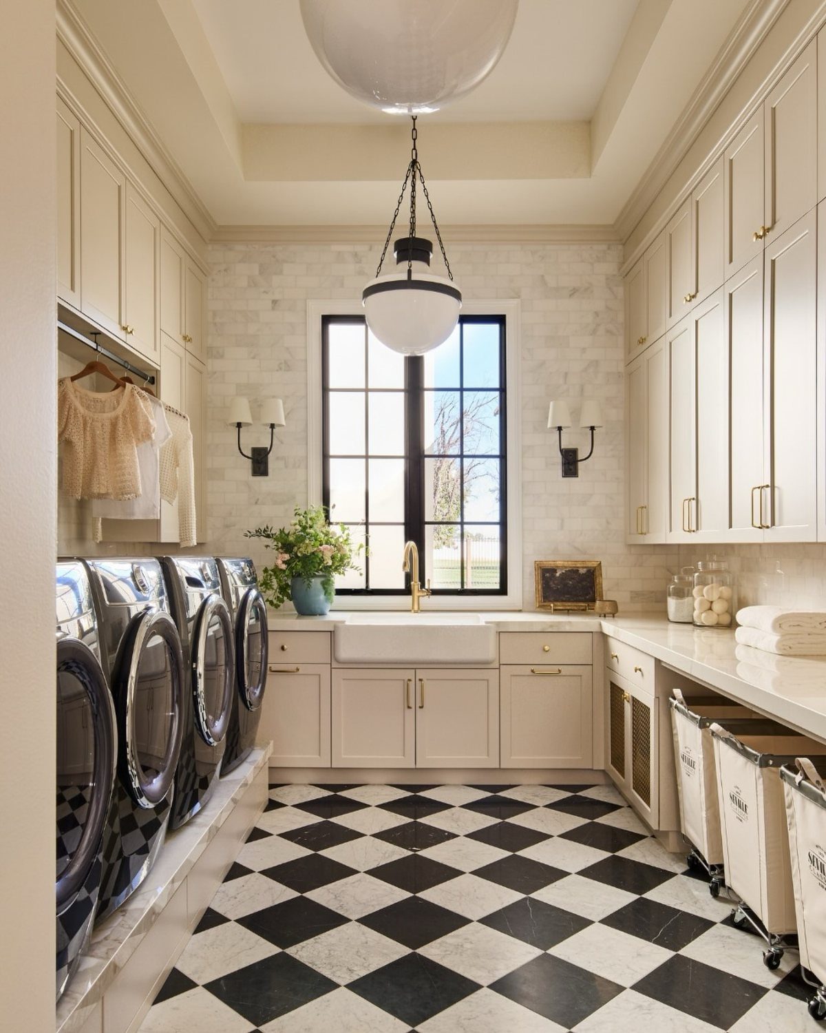 Floor Tile for Laundry Room: 11 Styles That Hold Up to Real Life 11 Black and white checkerboard tiles on a laundry room floor with white cabinets and appliances.