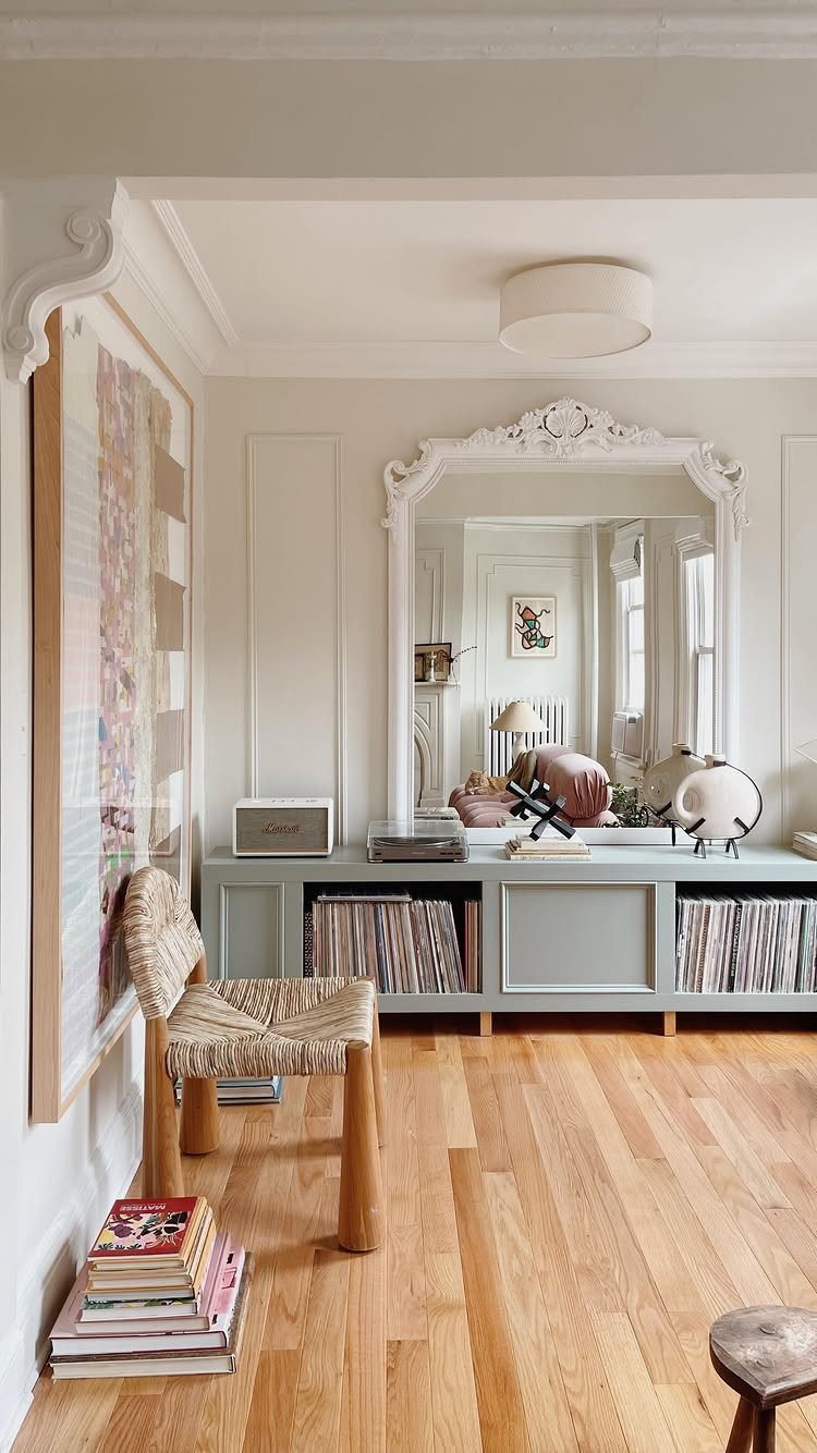 White crown molding lines the ceiling in a bright living room with light wood floors.