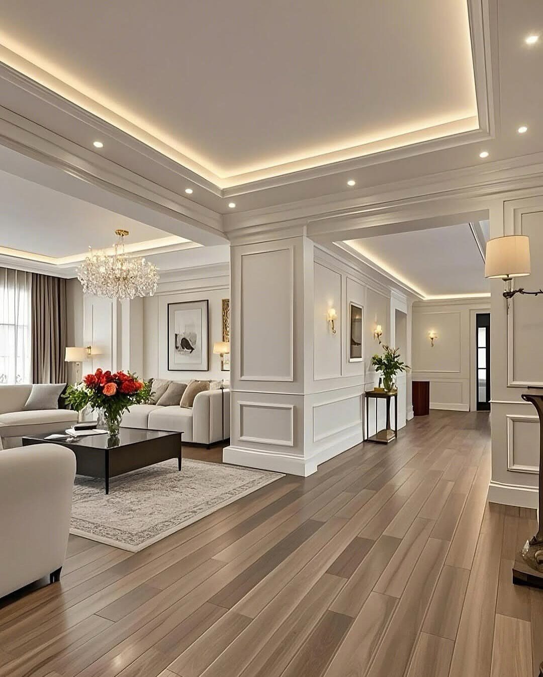 Modern living room with white wainscoting, recessed ceiling lights, and elegant white furniture.