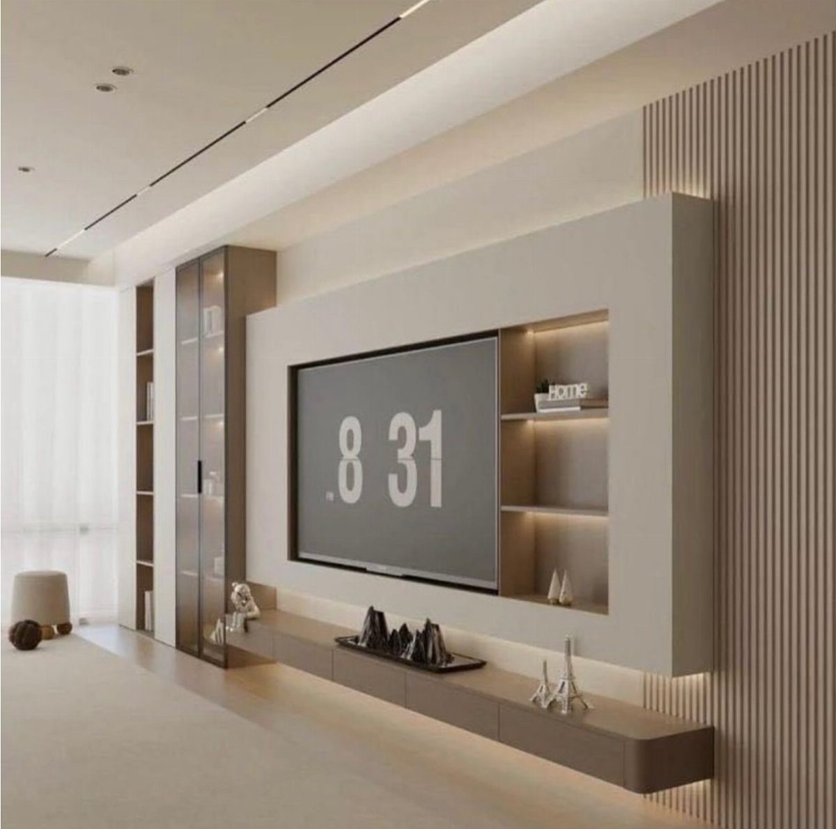 A modern recessed TV wall unit with integrated shelving and a long floating console in a living room.