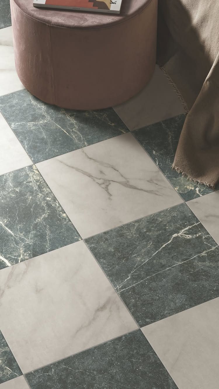 Checkerboard pattern of dark green and light gray marble tiles on a floor.