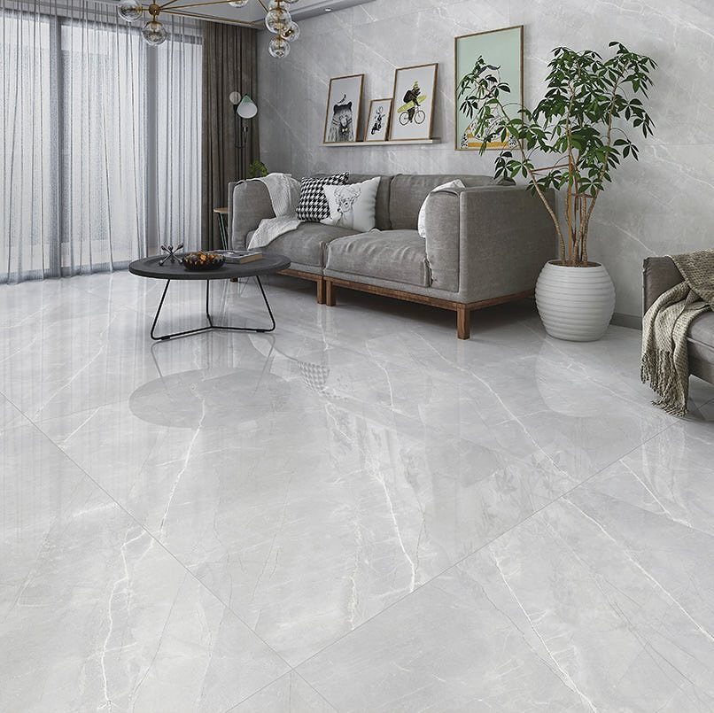 Polished gray marble tiles with white veining in a modern living room setting.
