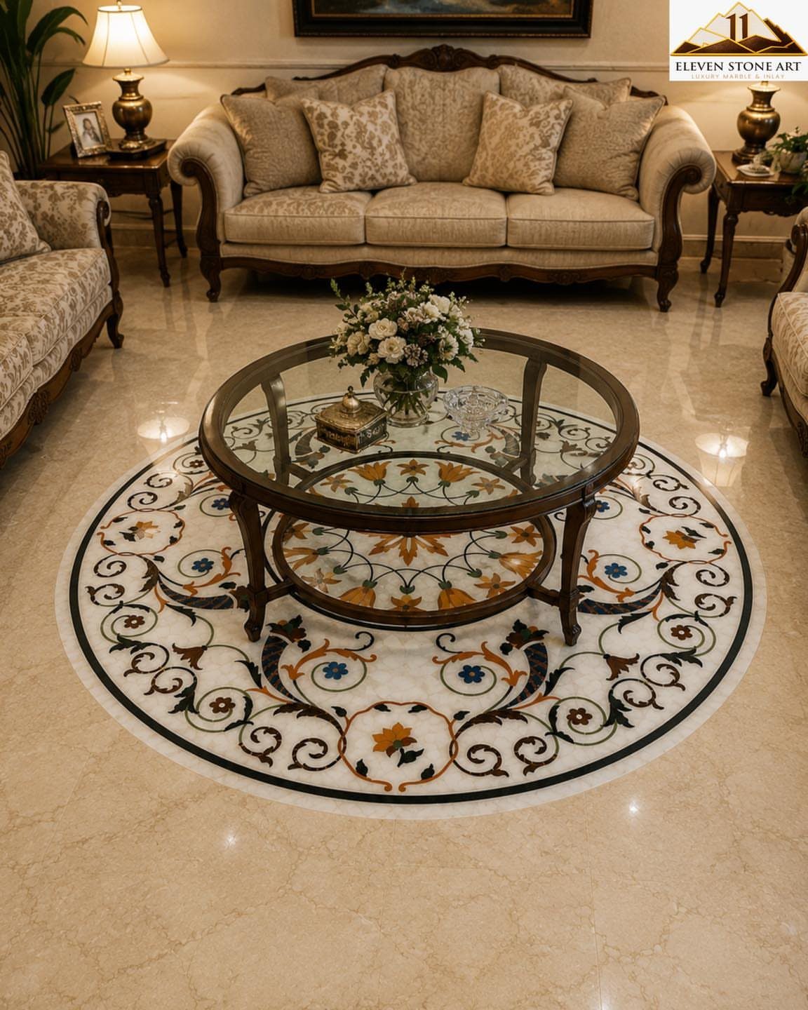 Circular marble floor medallion with colorful floral inlay patterns located under a glass coffee table.