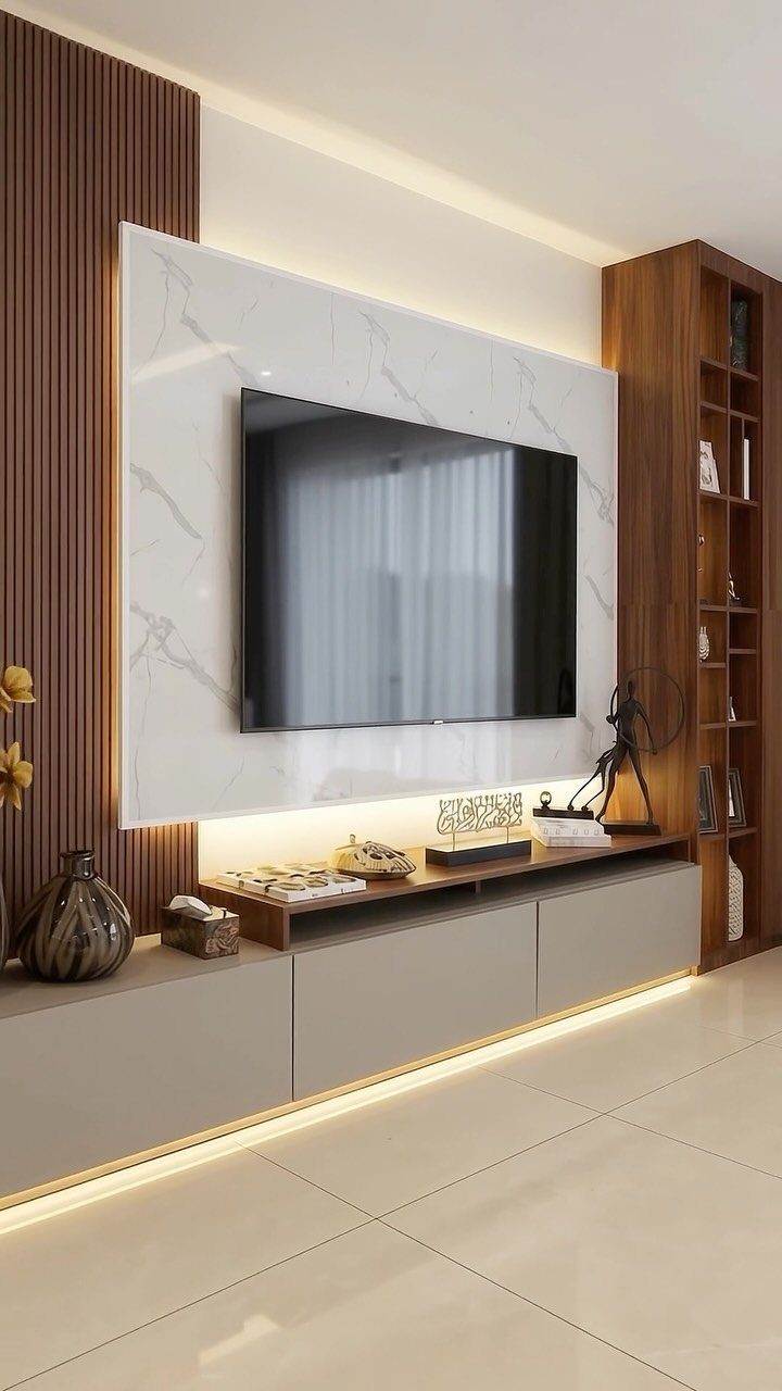 A white marble-effect floating TV panel with LED backlighting mounted on a wood-slatted wall.