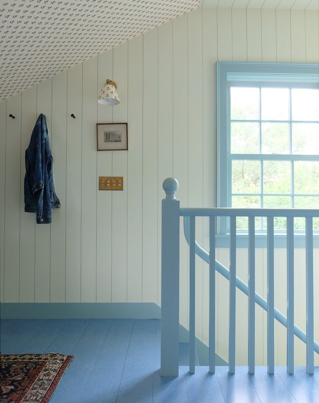 5 Painted Wood Floors for Pattern, Pale Color, and Bold Graphics 4 Light blue painted wooden floors in a bright room with white paneled walls and blue trim.