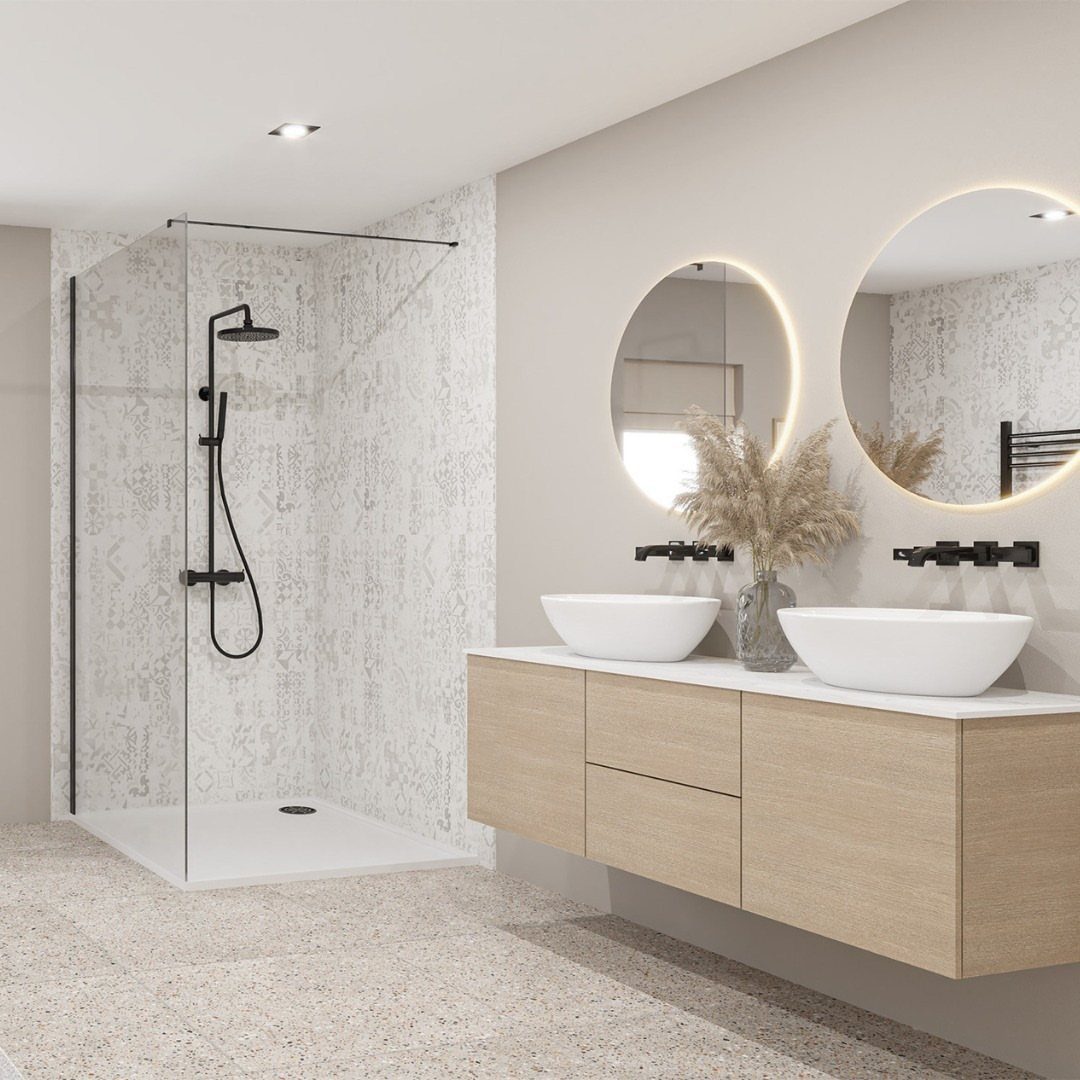 Modern bathroom with patterned white wall panels, glass shower, backlit mirrors, and a wooden floating vanity.