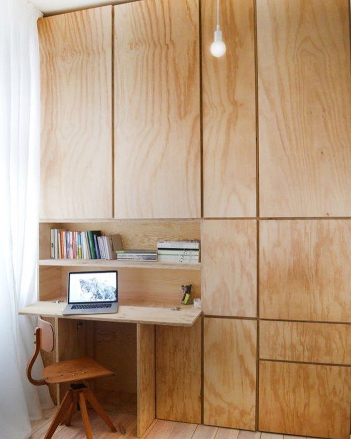 12 Plywood Wall Ideas for Living Rooms, Offices and Bedrooms 11 Plywood built-in desk and shelving unit with books and a laptop in a bright room.