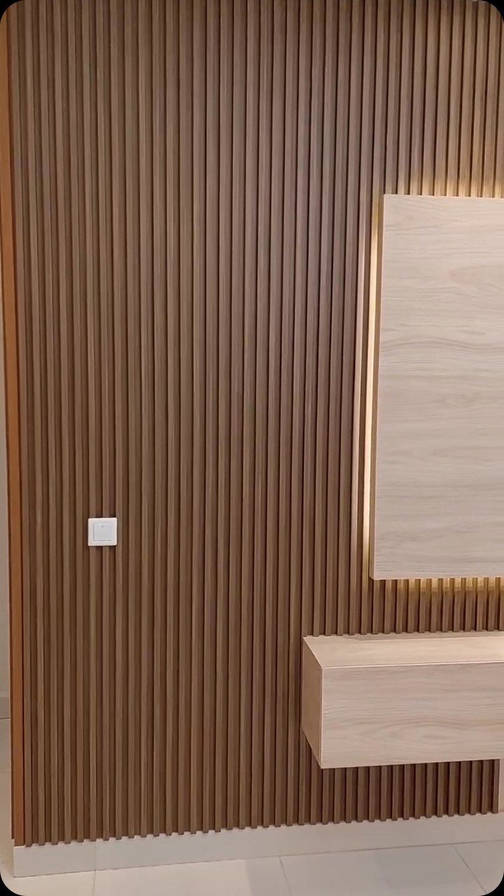 12 Plywood Wall Ideas for Living Rooms, Offices and Bedrooms 8 Fluted wood panel wall with floating wooden shelves and warm LED backlighting.