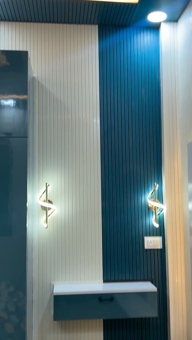 PVC Panel Design: 9 Ideas for Walls, Ceilings and Exteriors 4 Vertical white and teal blue PVC wall panels with decorative gold wall sconces and a floating drawer.