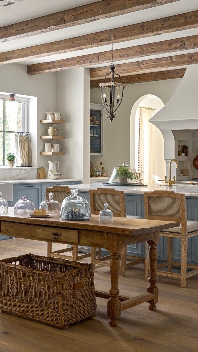 29 Rustic Farmhouse Kitchen Ideas That Feel Collected, Not Cataloged 9 Weathered wood ceiling beams and a rustic wooden dining table in a farmhouse kitchen.