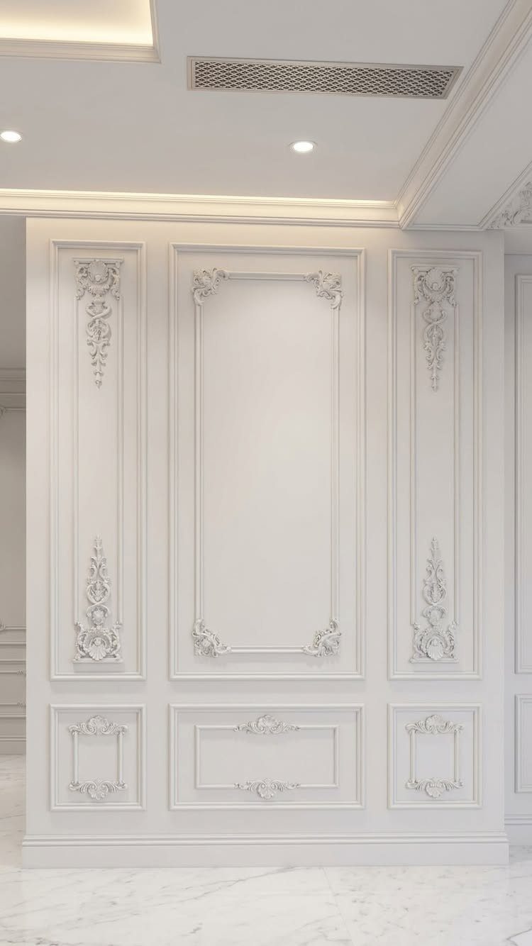 Ornate white wall paneling with intricate floral carvings and decorative rectangular moulding patterns.