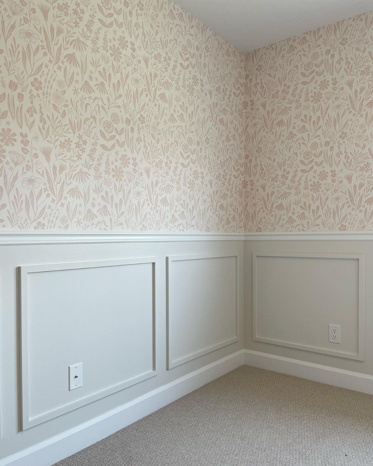 Trim Work on Walls: 8 Styles That Add Detail to Any Room 2 White wainscoting with a chair rail trim under floral patterned wallpaper in a room corner.