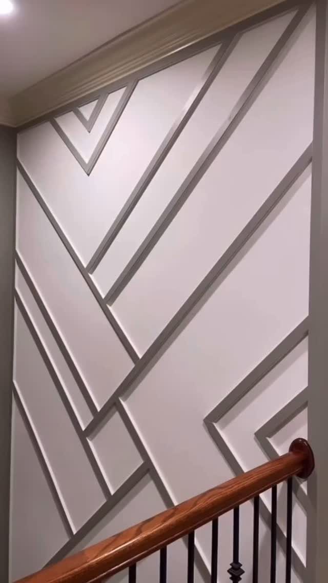 Trim Work on Walls: 8 Styles That Add Detail to Any Room 7 Geometric wooden trim patterns arranged in diagonal lines on a white interior wall.