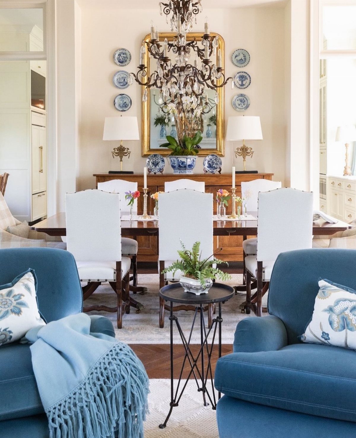 23 Wall Decor Design Ideas (Gallery Walls, Moss Walls, Rattan) 6 Symmetrical wall decor featuring a gold mirror, matching plates, and lamps above a dining sideboard.