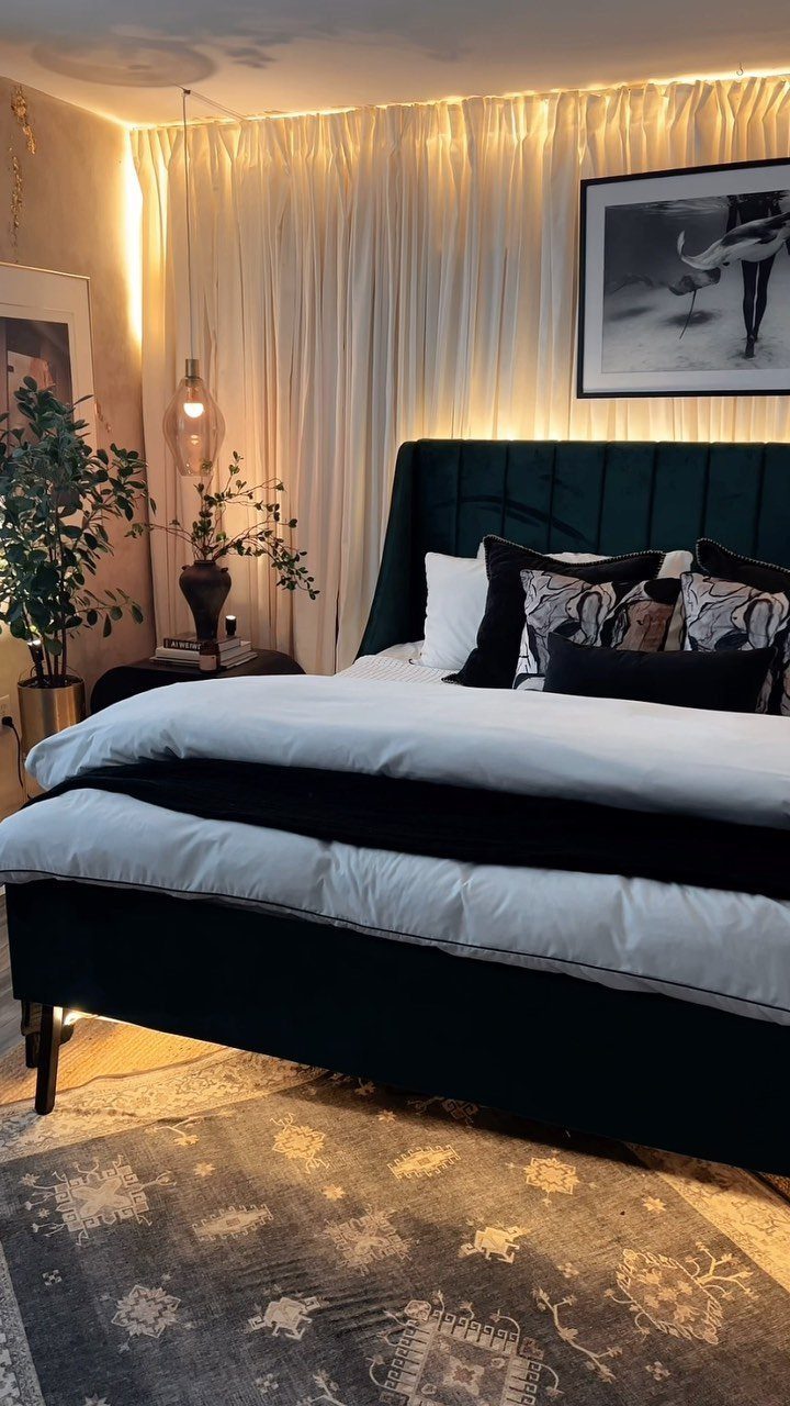 23 Wall Decor Design Ideas (Gallery Walls, Moss Walls, Rattan) 17 White floor-to-ceiling drapery covers a bedroom wall behind a dark green velvet bed.