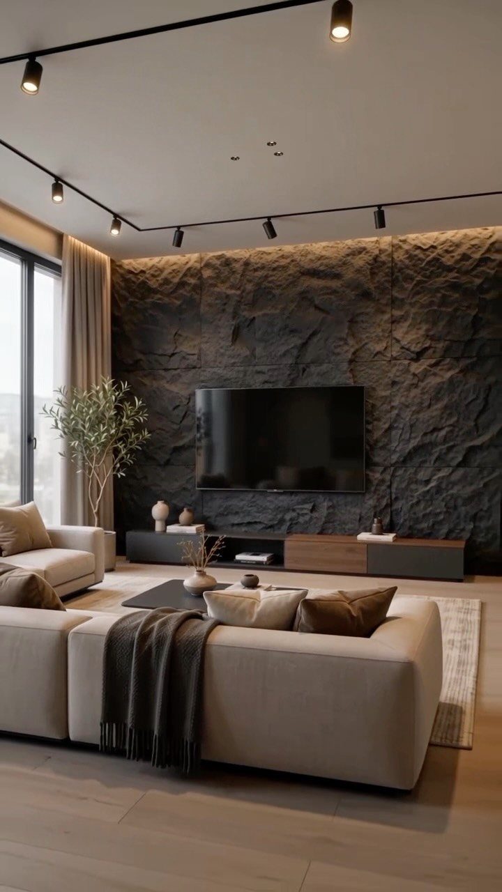 Textured dark stone accent wall panels behind a television in a modern living room.