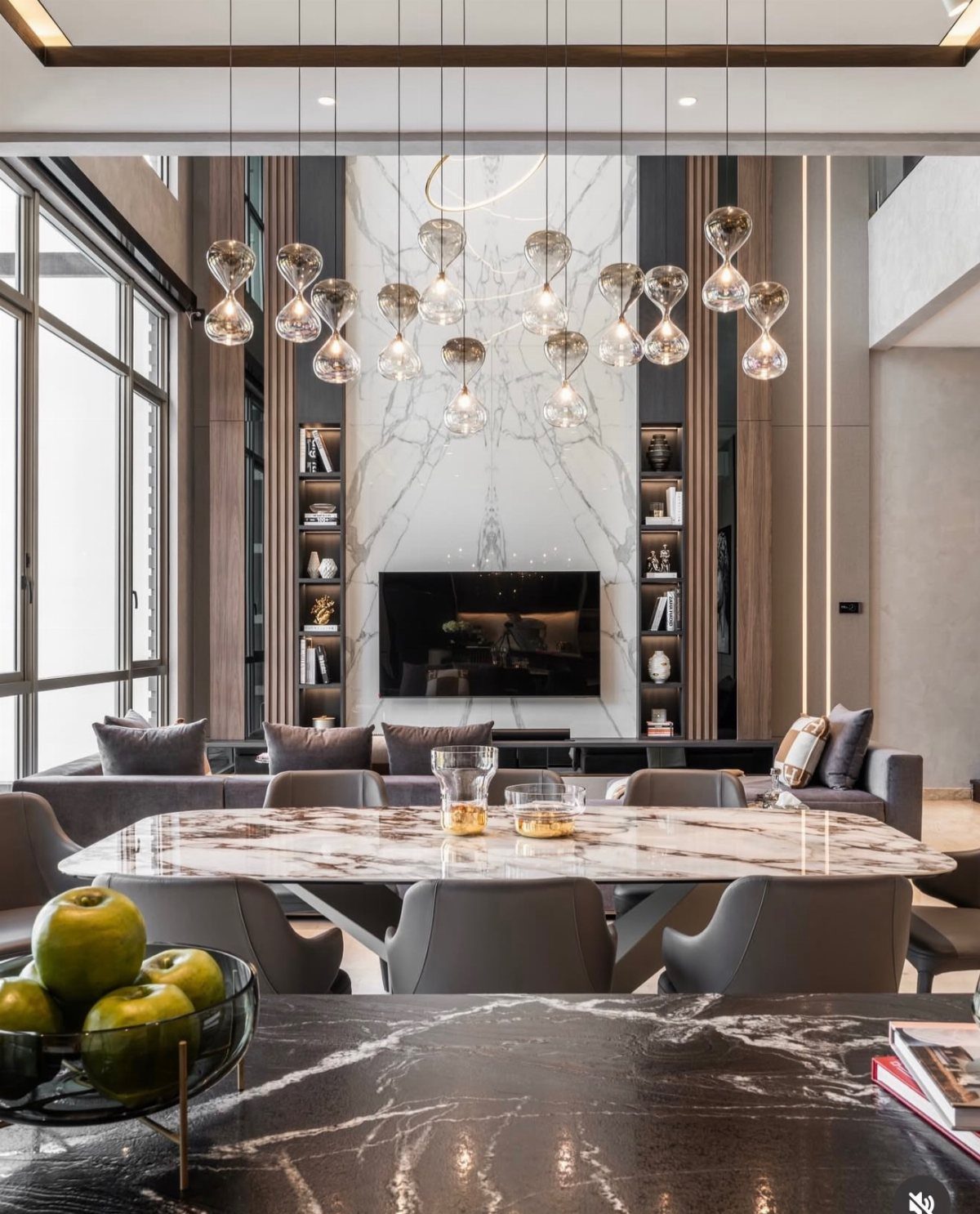 Marble patterned wall paneling behind a television in a modern living room setting.