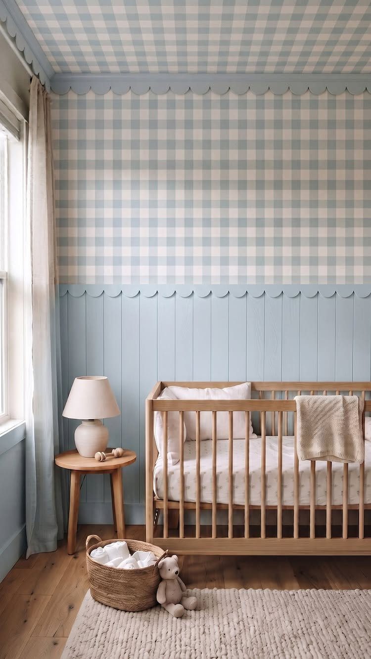 Blue and white gingham wallpaper covering the walls and ceiling of a nursery with a wooden crib.