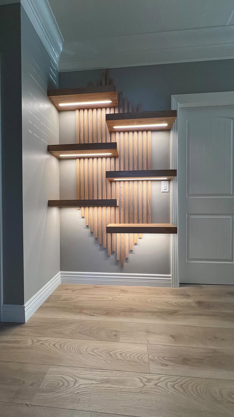 Dark wood floating shelves with integrated lighting mounted on a vertical wood slat accent wall.