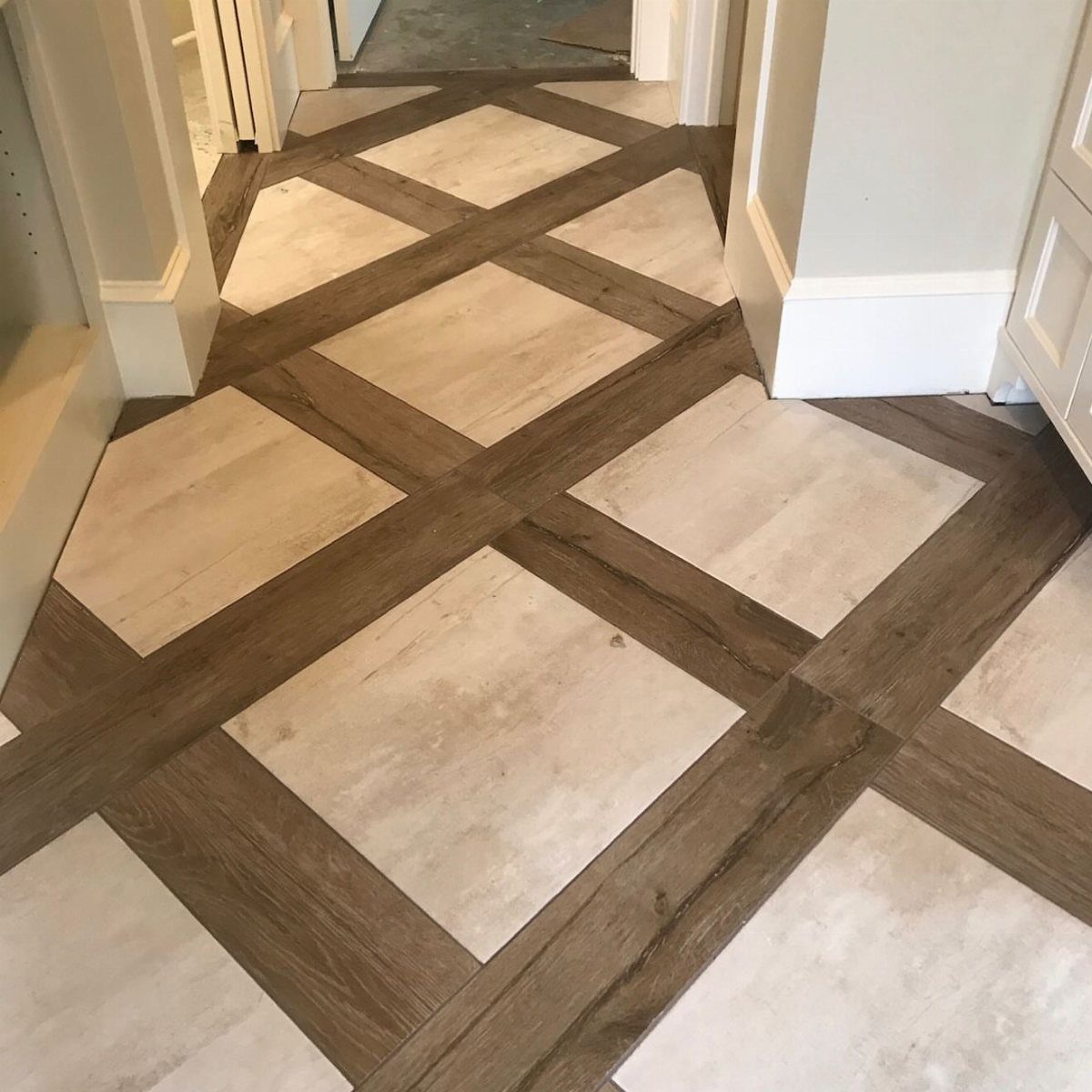 Wood Tile Pattern: 6 Layouts That Actually Work 6 Diagonal wood and light tile pattern flooring installed in a home hallway.