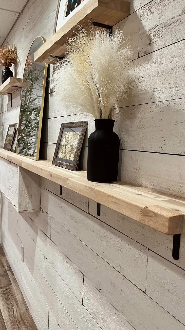 Wooden Plank Design: 6 Looks for Walls and Accents 2 White-washed shiplap wall planks with a wooden shelf holding a black vase and dried grass.